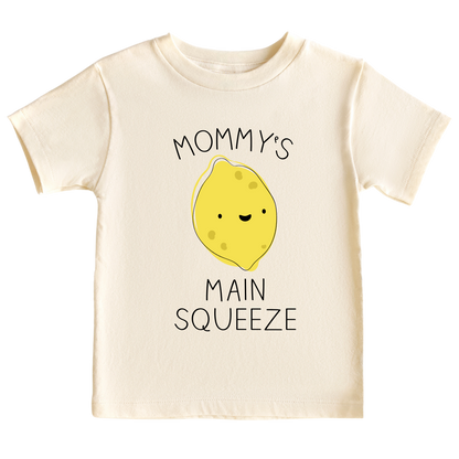 A kid's t-shirt with a cute printed graphic of a lemon and the text 'Mama's Main Squeeze.' This adorable t-shirt celebrates the special bond between a child and their mama. 