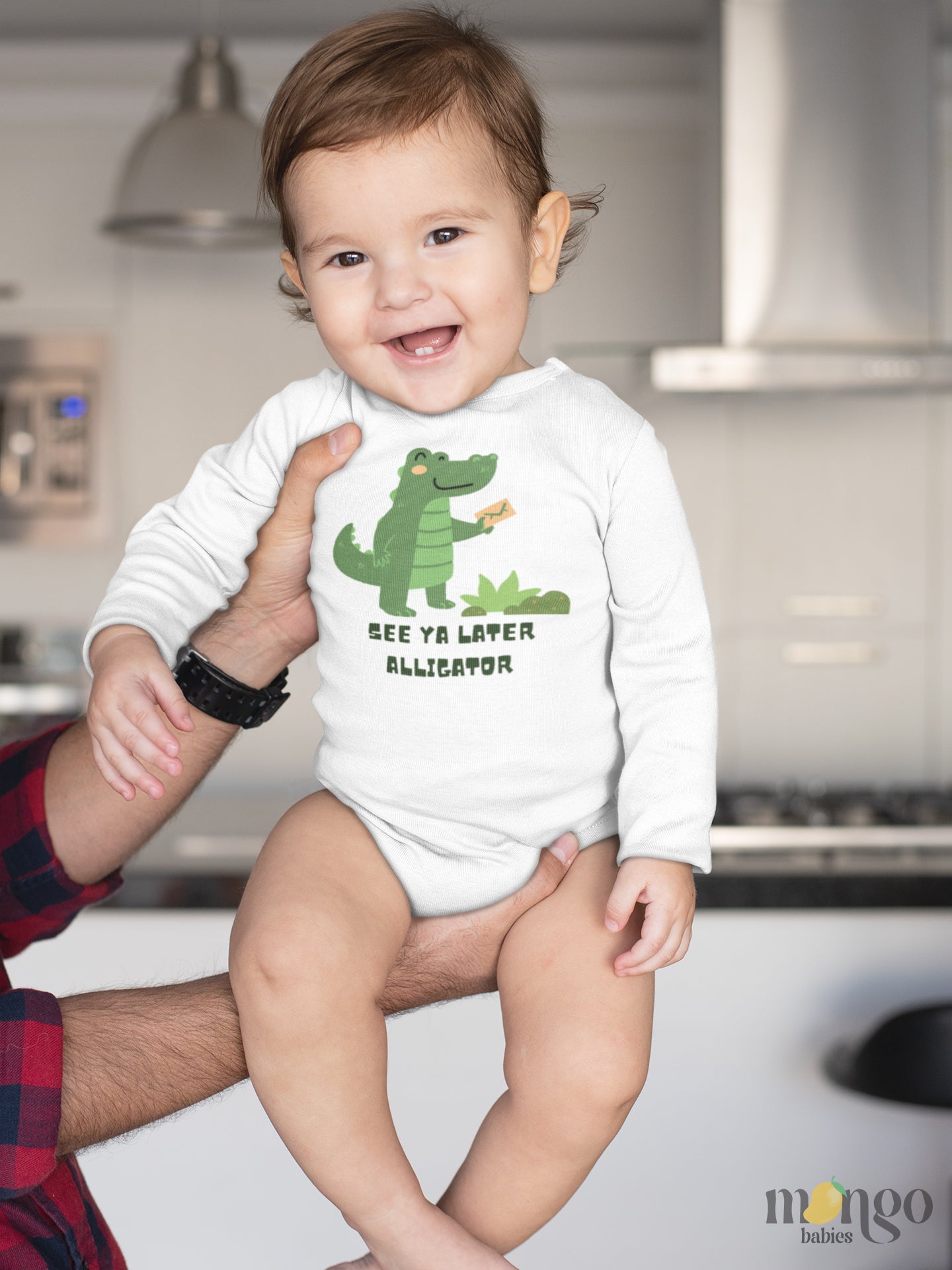 Long sleeve onesie showcasing a playful printed graphic of an alligator and the text 'See Ya Later Alligator.' Explore this delightful tee that adds a touch of whimsy and charm to your child's wardrobe.