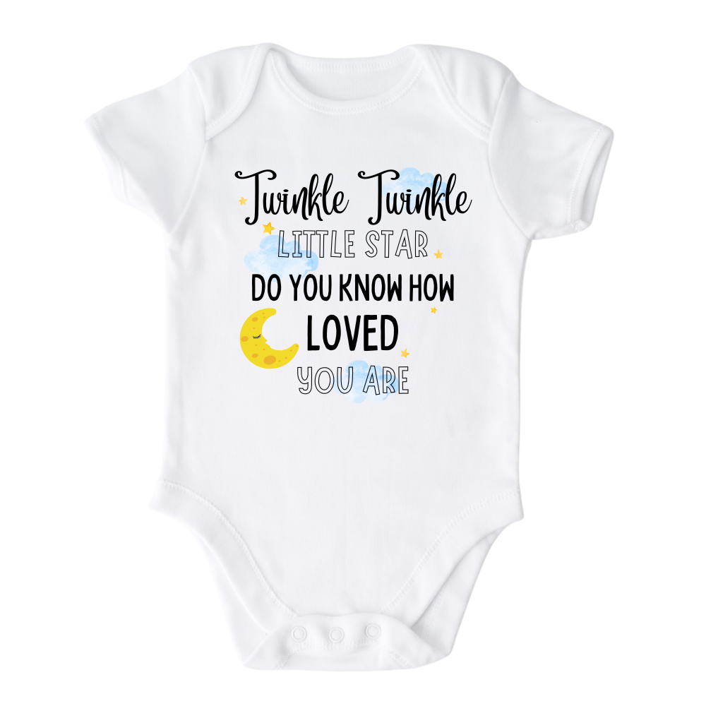 A kids' t-shirt with a captivating night sky graphic adorned with stars and a moon cup. The text reads 'Twinkle Twinkle Little Star, Do You Know How Loved You Are?' The design embodies a sense of magic, love, and wonder, inspiring imagination and admiration.