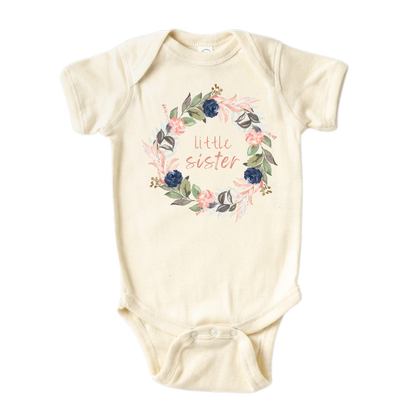 Natural Onesie with a cute printed graphic of a floral wreath and the text 'Little Sister.' This adorable t-shirt celebrates the arrival of a precious little sister.