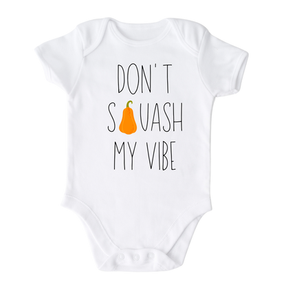 White Onesie t-shirt featuring a fall-themed printed graphic of a squash and the fun text 'Don't Squash My Vibe.' Explore this trendy tee, perfect for embracing autumn style. 