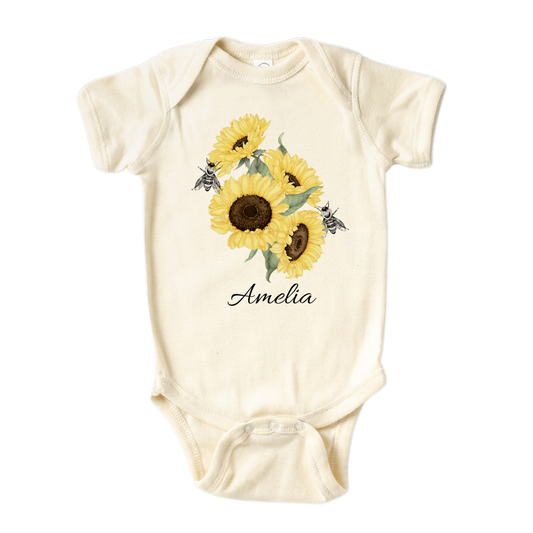 Baby Onesie A kid's t-shirt with a cute printed graphic of sunflowers and bees, personalized with a customized name. This delightful tee is stylish, comfortable, and made from high-quality materials. 