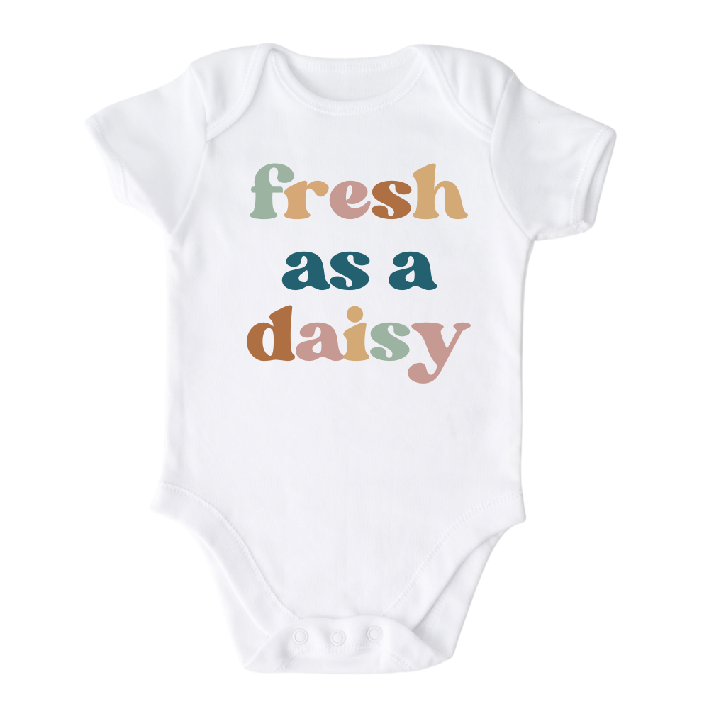 White Bodysuit with a colorful graphic of the text 'Fresh as a daisy.' This vibrant design adds a cheerful and trendy touch to your child's outfit.