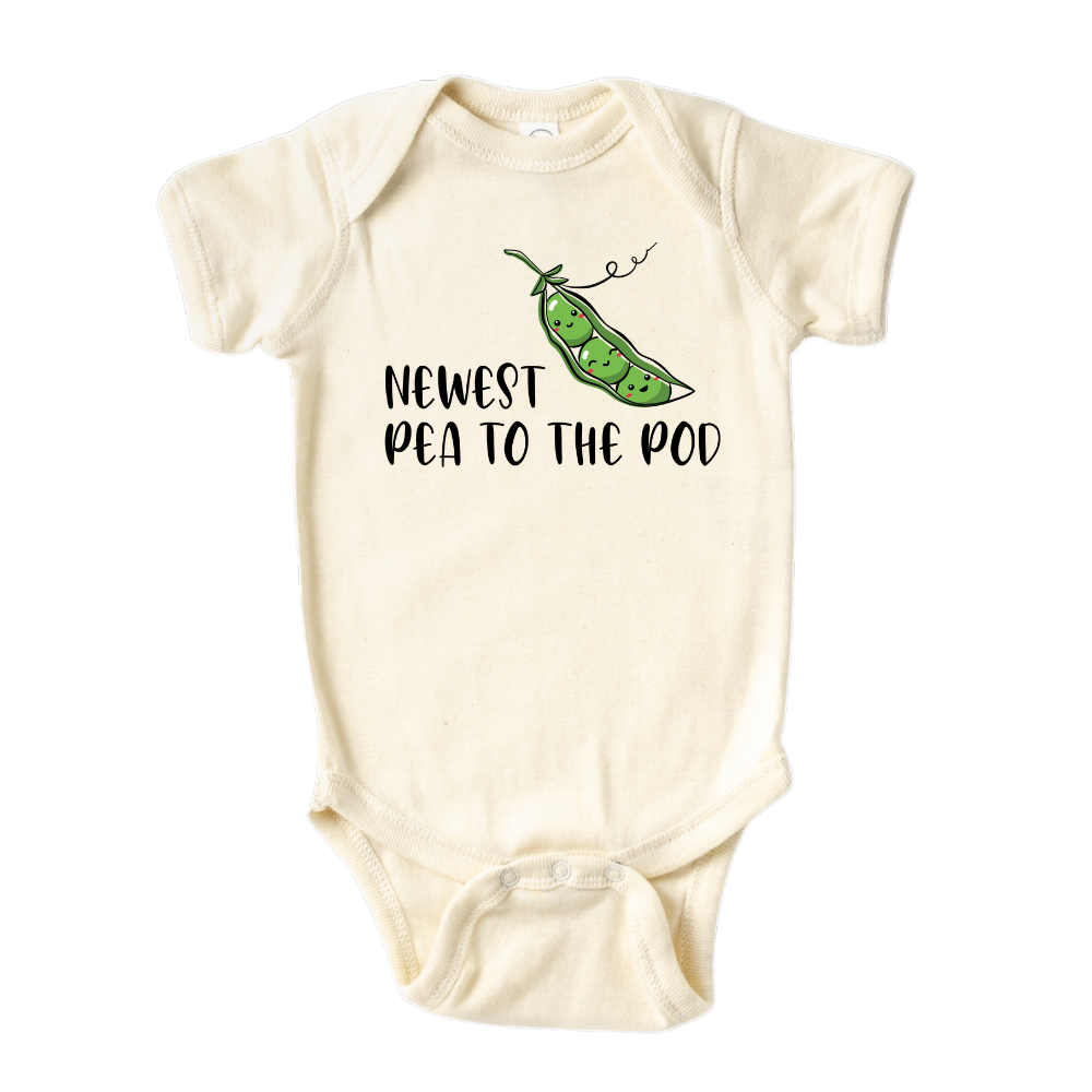 Natural Short Sleeve Baby Bodysuit with a pea icon and the text 'Newest Pea to The Pod.' This adorable design symbolizes the arrival of a new family member, capturing the joy and excitement. Celebrate your little one with this cute and stylish tee.