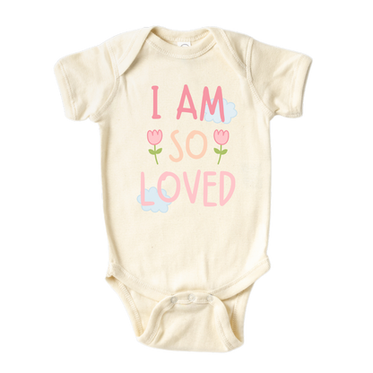 Natural Onesie with a pastel graphic of the text 'I am so loved.' This heartwarming design represents the unconditional love surrounding your child. 