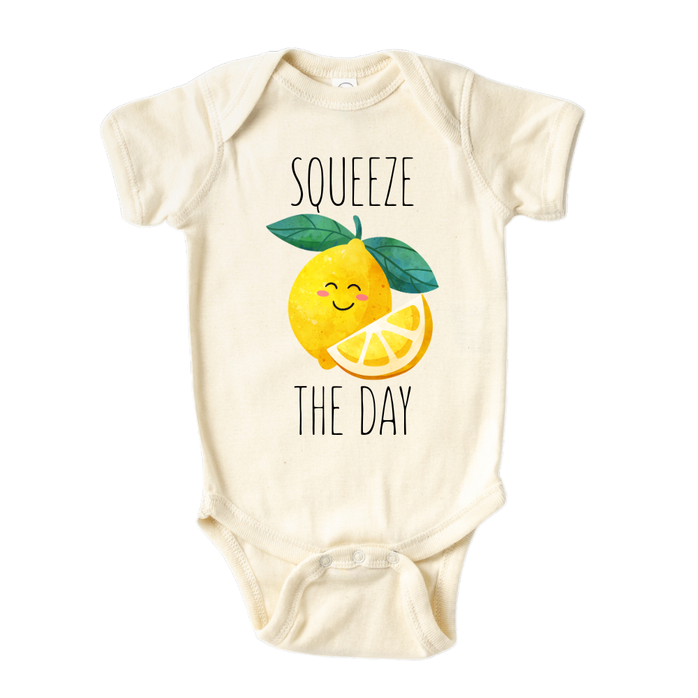 Natural Baby Bodysuit showcasing a playful printed graphic of a lemon with the text 'Squeeze The Day.' Explore this vibrant and motivational tee, perfect for adding a burst of positivity to your child's wardrobe.