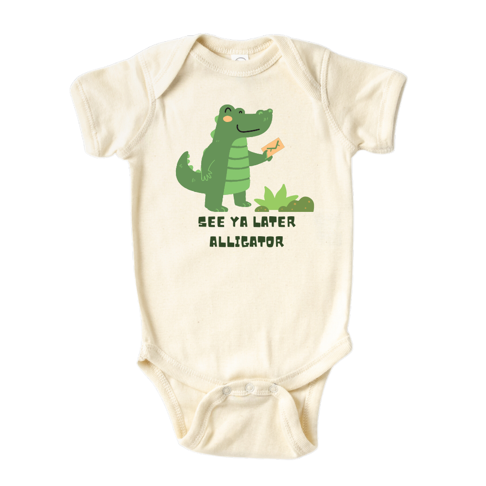 Natural Baby Onesie showcasing a playful printed graphic of an alligator and the text 'See Ya Later Alligator.' Explore this delightful tee that adds a touch of whimsy and charm to your child's wardrobe.