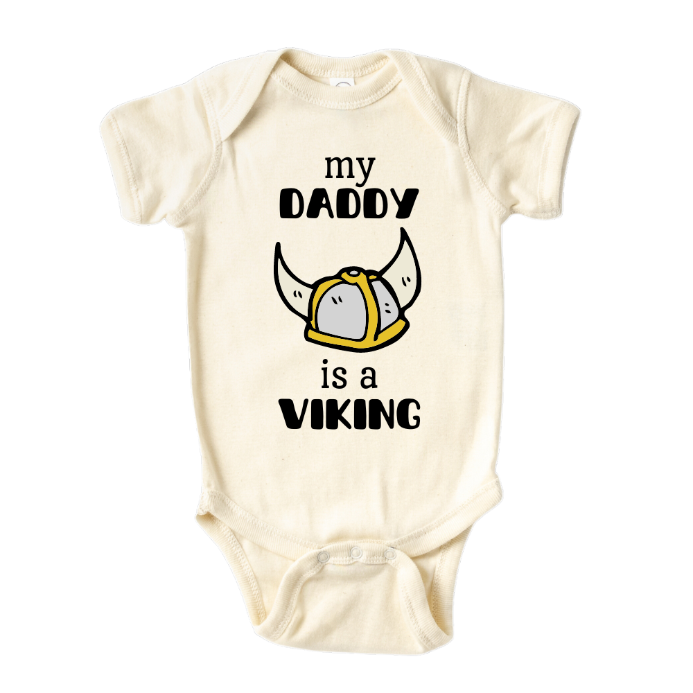 Natural Onesie with a printed graphic of the text 'My daddy is a viking.' This playful design celebrates the strong bond between a child and their Viking dad.