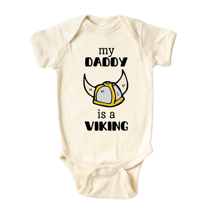 Natural Onesie with a printed graphic of the text 'My daddy is a viking.' This playful design celebrates the strong bond between a child and their Viking dad.