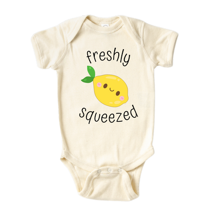 A kids' t-shirt with an adorable graphic of a cute lemon and the text 'Freshly Squeezed.' This design captures the refreshing and playful nature of the citrus fruit, adding a vibrant touch to the wearer's style. It's a delightful and eye-catching tee that stands out with its zestful charm.