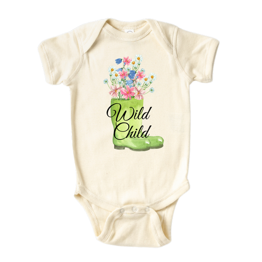 A kids' t-shirt with a whimsical graphic of a green boot adorned with blooming flowers inside. The text reads 'Wild Child,' capturing the essence of a free-spirited and adventurous nature. The design symbolizes the beauty and vitality found in embracing the wild side of life.