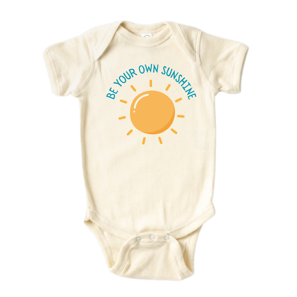 Natural Baby Onesie featuring an adorable printed graphic of a sun with the empowering text 'Be Your Own Sunshine.' Encourage positivity and self-confidence with this delightful tee. 