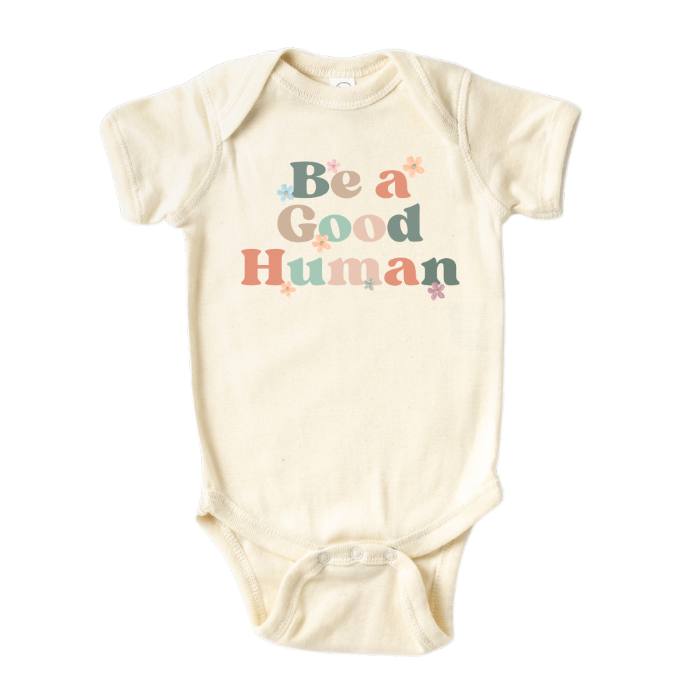 Natural Baby Bodysuit with retro printed graphic of 'Be A Good Human' text, promoting kindness and positivity. Shop now and inspire your little one to make a positive impact. Perfect addition to their stylish wardrobe.