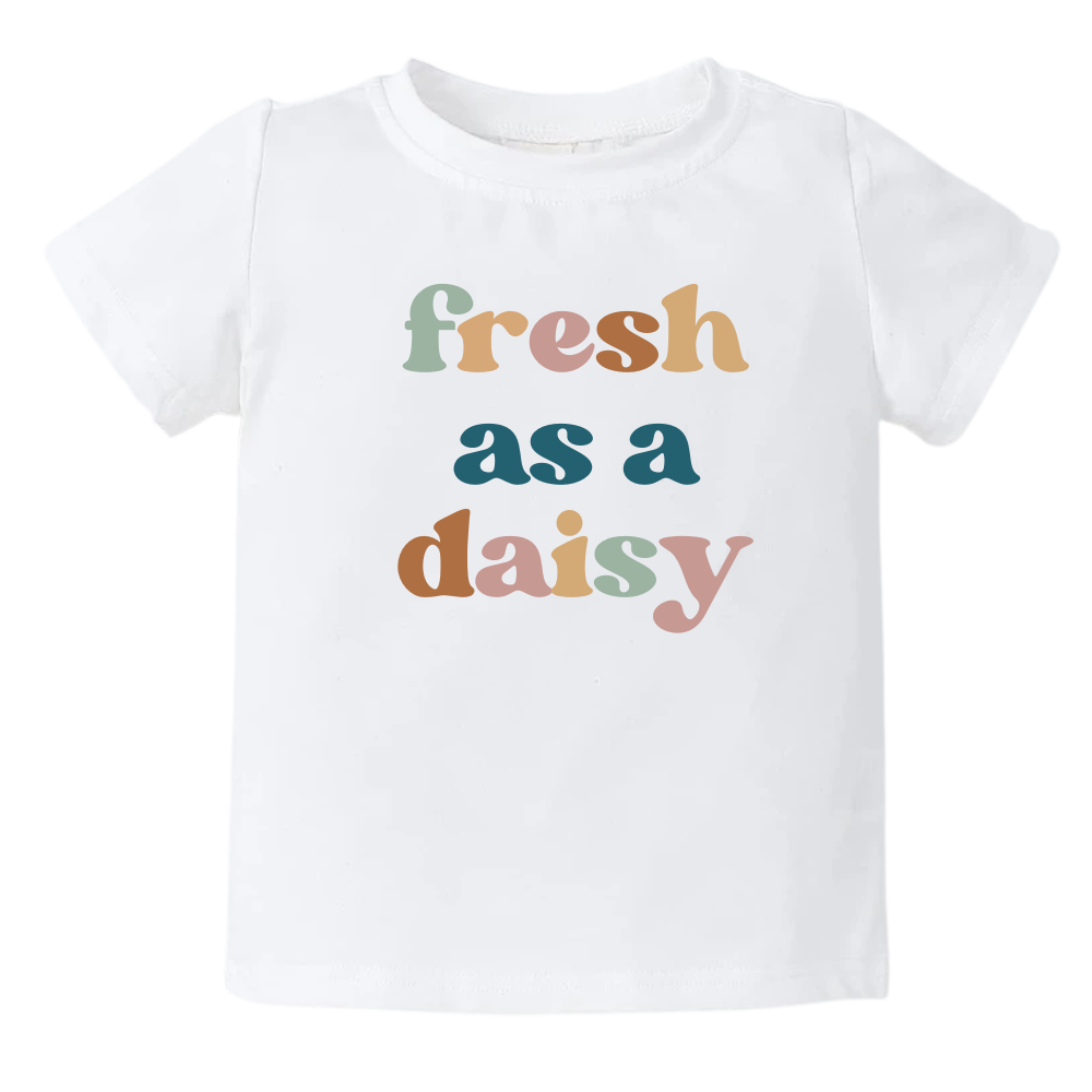 White kids' t-shirt with a colorful graphic of the text 'Fresh as a daisy.' This vibrant design adds a cheerful and trendy touch to your child's outfit.