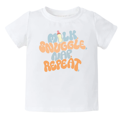 White Tshirt for Kid with a fun printed graphic and the text 'Milk Snuggle Nap Repeat.' This playful and cute design captures the essence of cozy and comforting moments. 