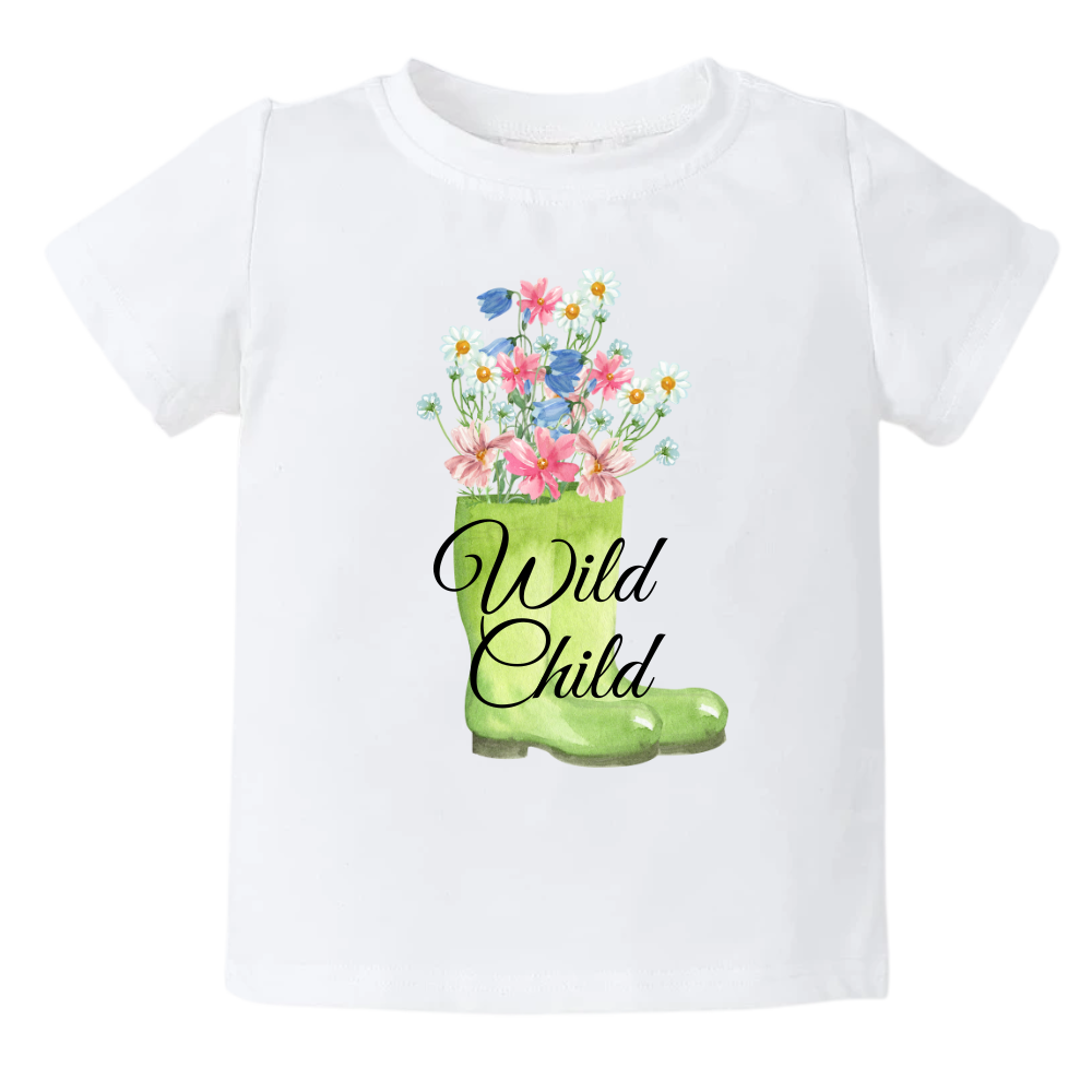 A kids' t-shirt with a whimsical graphic of a green boot adorned with blooming flowers inside. The text reads 'Wild Child,' capturing the essence of a free-spirited and adventurous nature. The design symbolizes the beauty and vitality found in embracing the wild side of life.