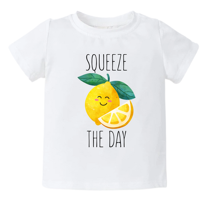 Kid's t-shirt showcasing a playful printed graphic of a lemon with the text 'Squeeze The Day.' Explore this vibrant and motivational tee, perfect for adding a burst of positivity to your child's wardrobe.