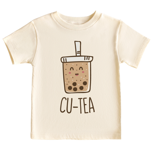 A kids' t-shirt with a charming graphic of a boba cup and the text 'Cu-tea.' The design captures the whimsical appeal of the popular tea drink and showcases the wearer's fondness for cuteness and trendy fashion.