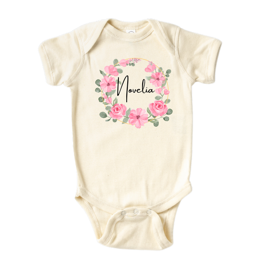 Kid's t-shirt with a cute pink floral wreath design, customizable with names.