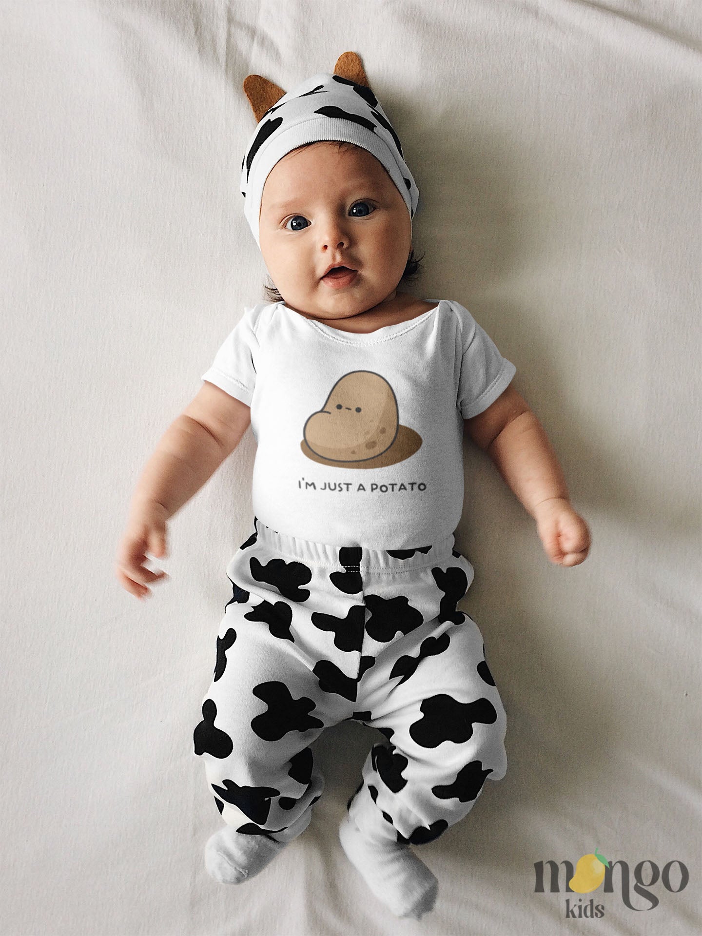 White Baby Bodysuit showcasing a playful printed graphic of a potato and the text 'I'm just a potato.' Explore this adorable tee that celebrates uniqueness and humor.