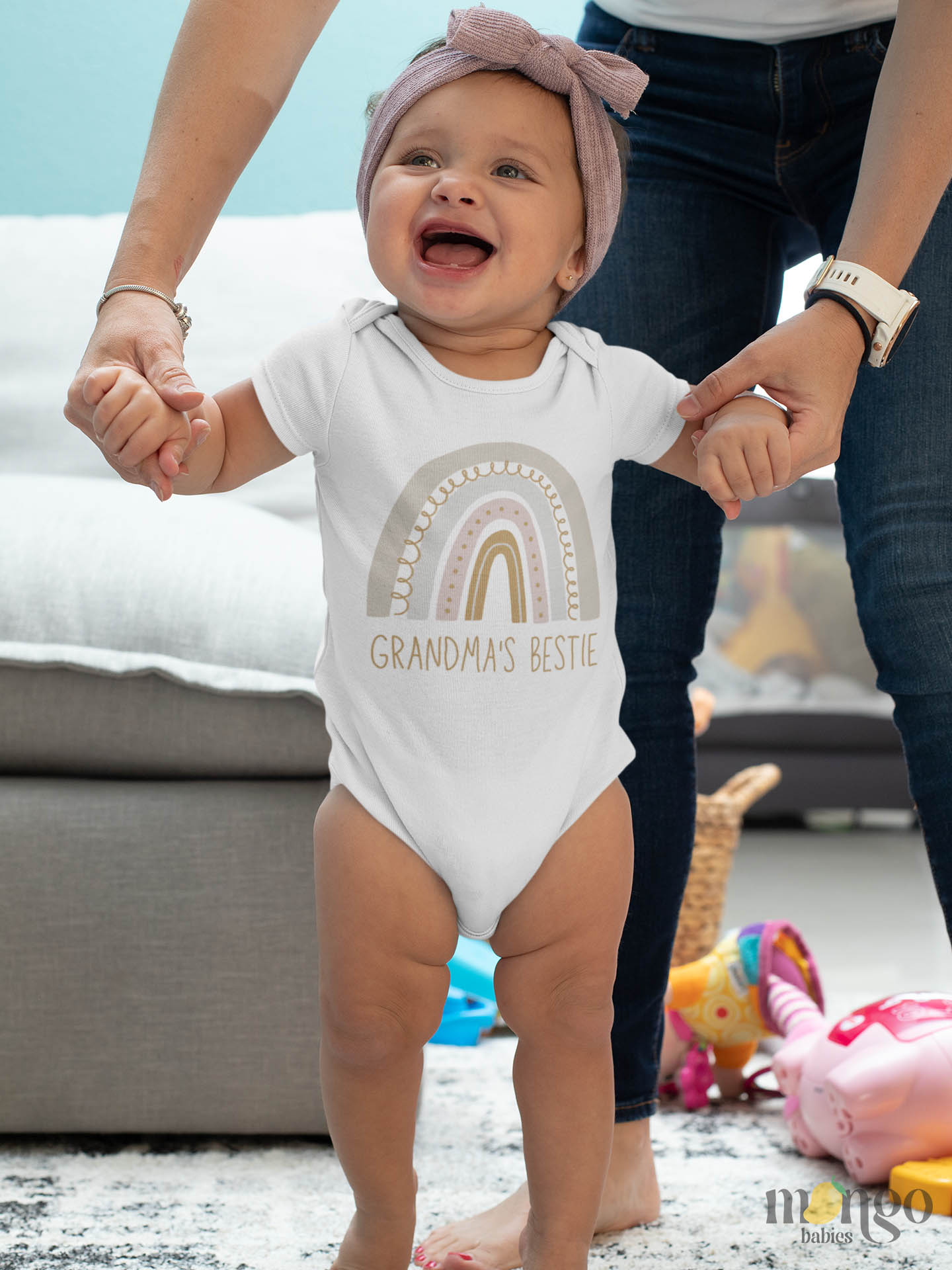 Baby Bodysuit adorned with a delightful printed graphic of a radiant rainbow and the text 'Auntie's Bestie.' This charming tee celebrates the cherished bond between a beloved aunt and her adored niece or nephew.
