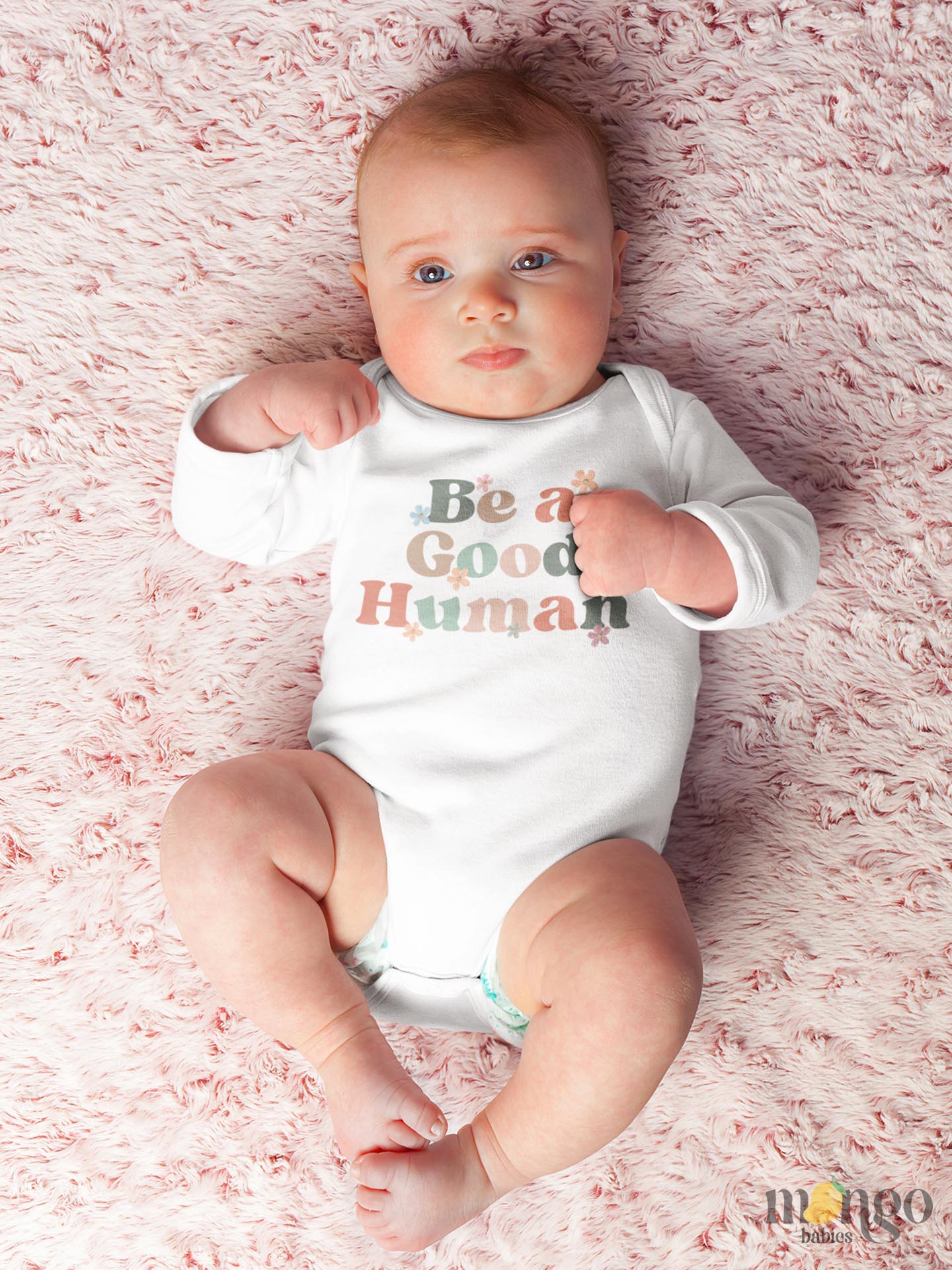 Long Sleeve Onesie with retro printed graphic of 'Be A Good Human' text, promoting kindness and positivity. Shop now and inspire your little one to make a positive impact. Perfect addition to their stylish wardrobe.