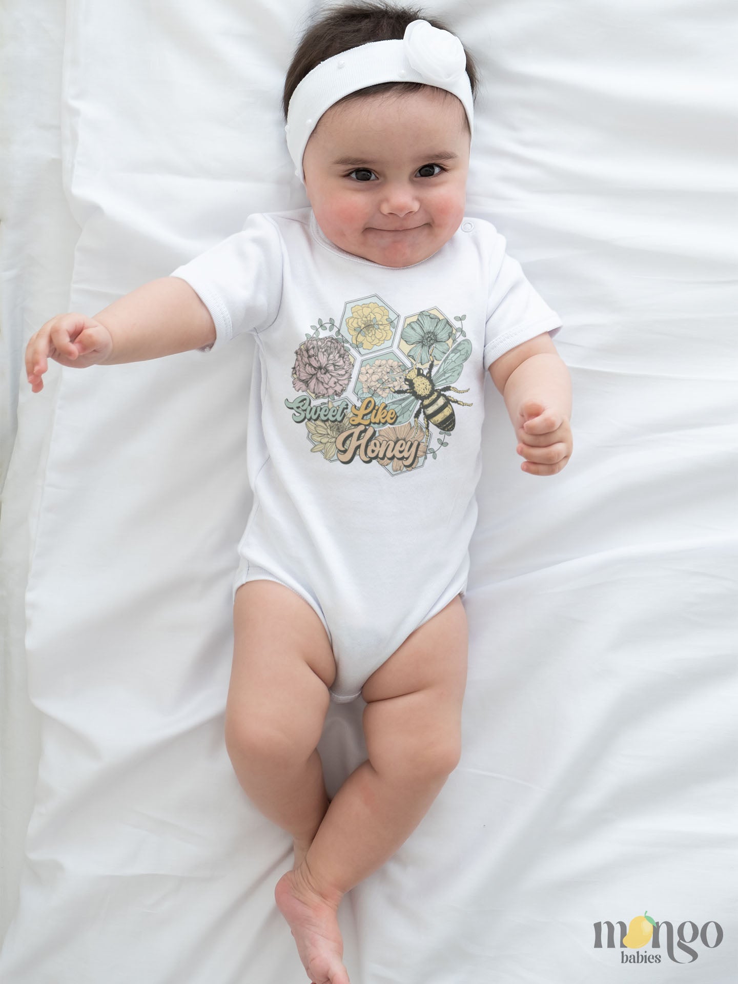 White Baby Bodysuit with a cute retro graphic of flowers and bees, and the text 'Sweet Like Honey.' Trendy and playful design for stylish outfits. 