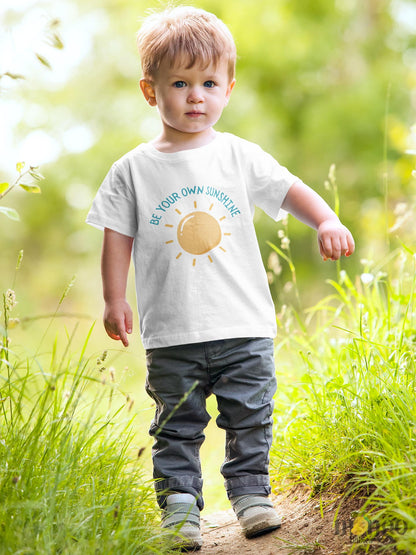 Kid's t-shirt featuring an adorable printed graphic of a sun with the empowering text 'Be Your Own Sunshine.' Encourage positivity and self-confidence with this delightful tee. 