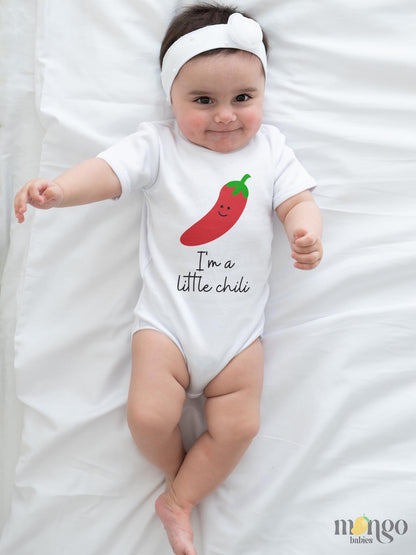 White onsie featuring a playful printed graphic of a chili and the text 'I'm A Little Chili.' Explore this vibrant and fun tee, perfect for adding a touch of spice to your child's wardrobe. 